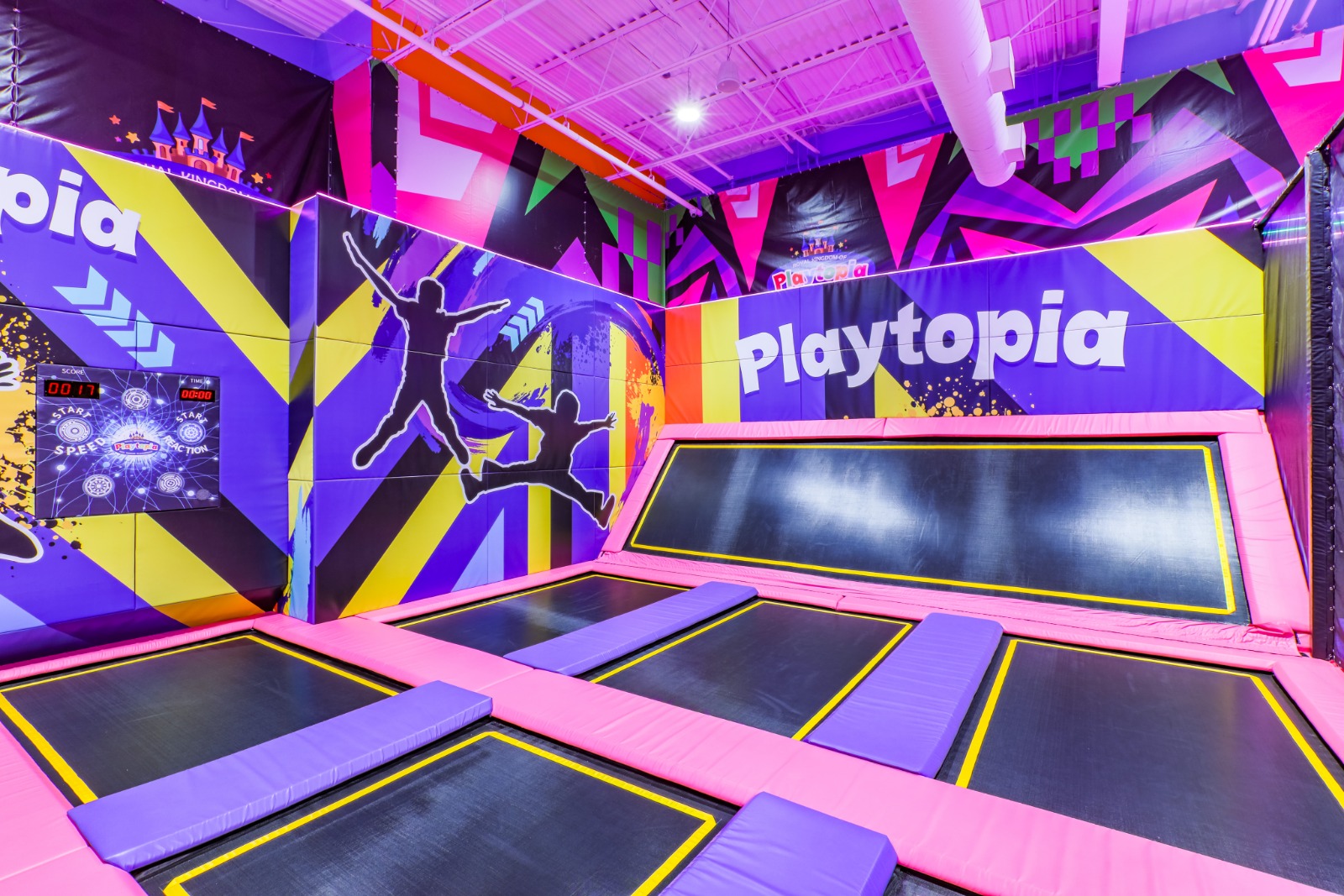 Angled wall trampolines with vibrant Playtopia murals.