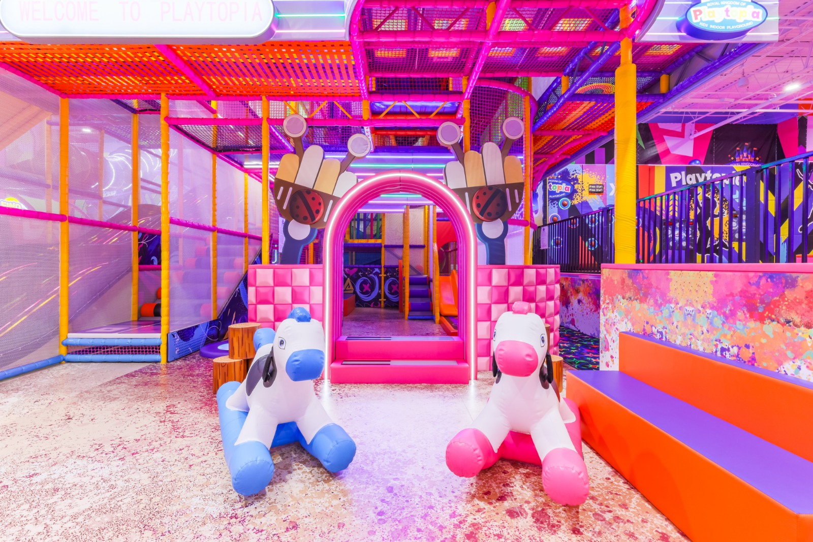 Animal rockers and soft play foam in a secure zone.