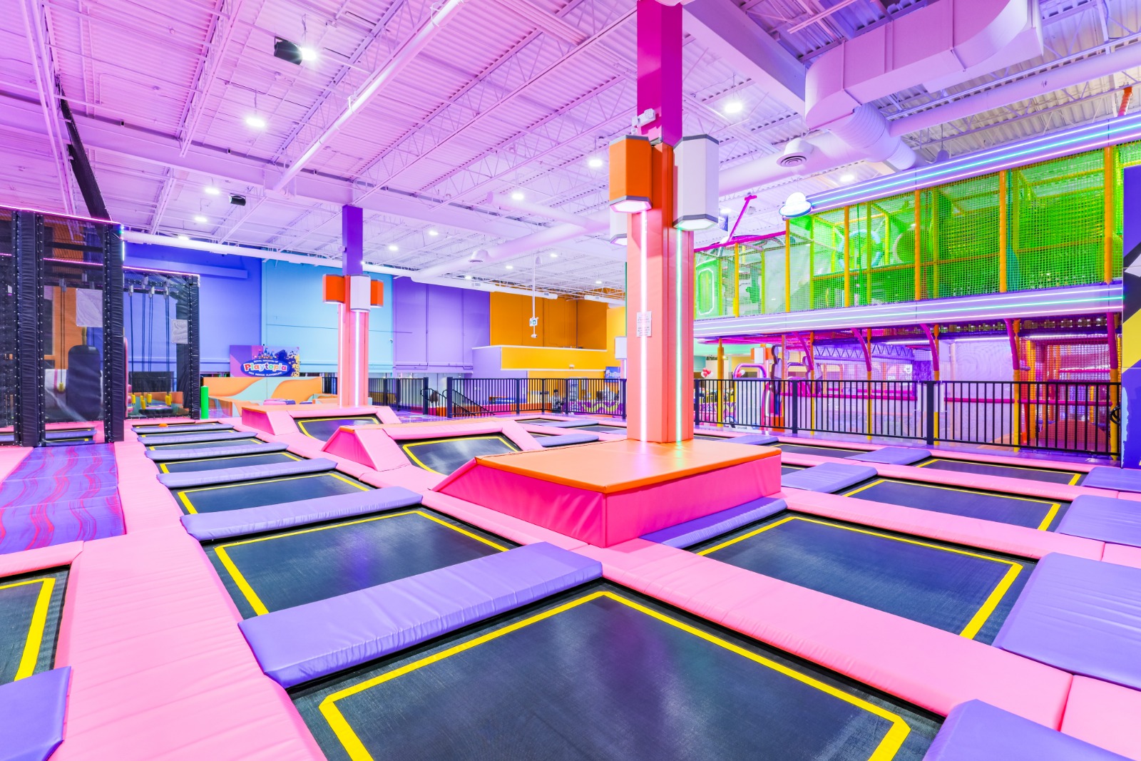 Large indoor trampoline park with multiple jump zones.