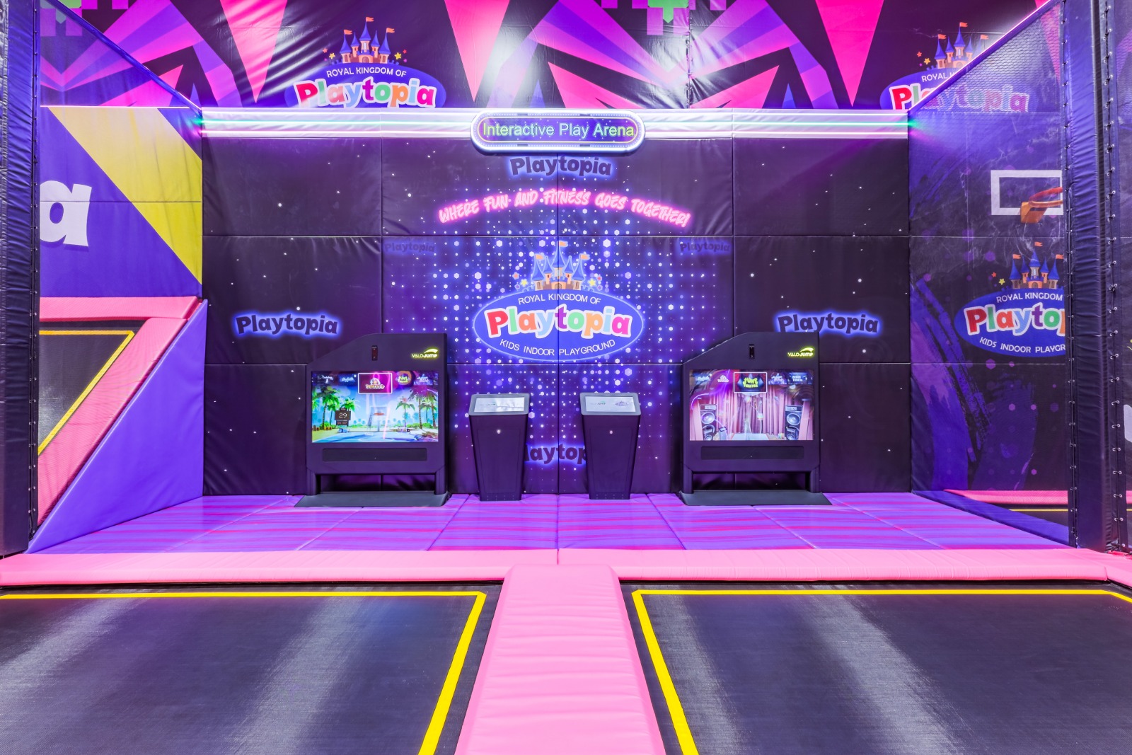 Wall-to-wall trampolines in a brightly lit arena.