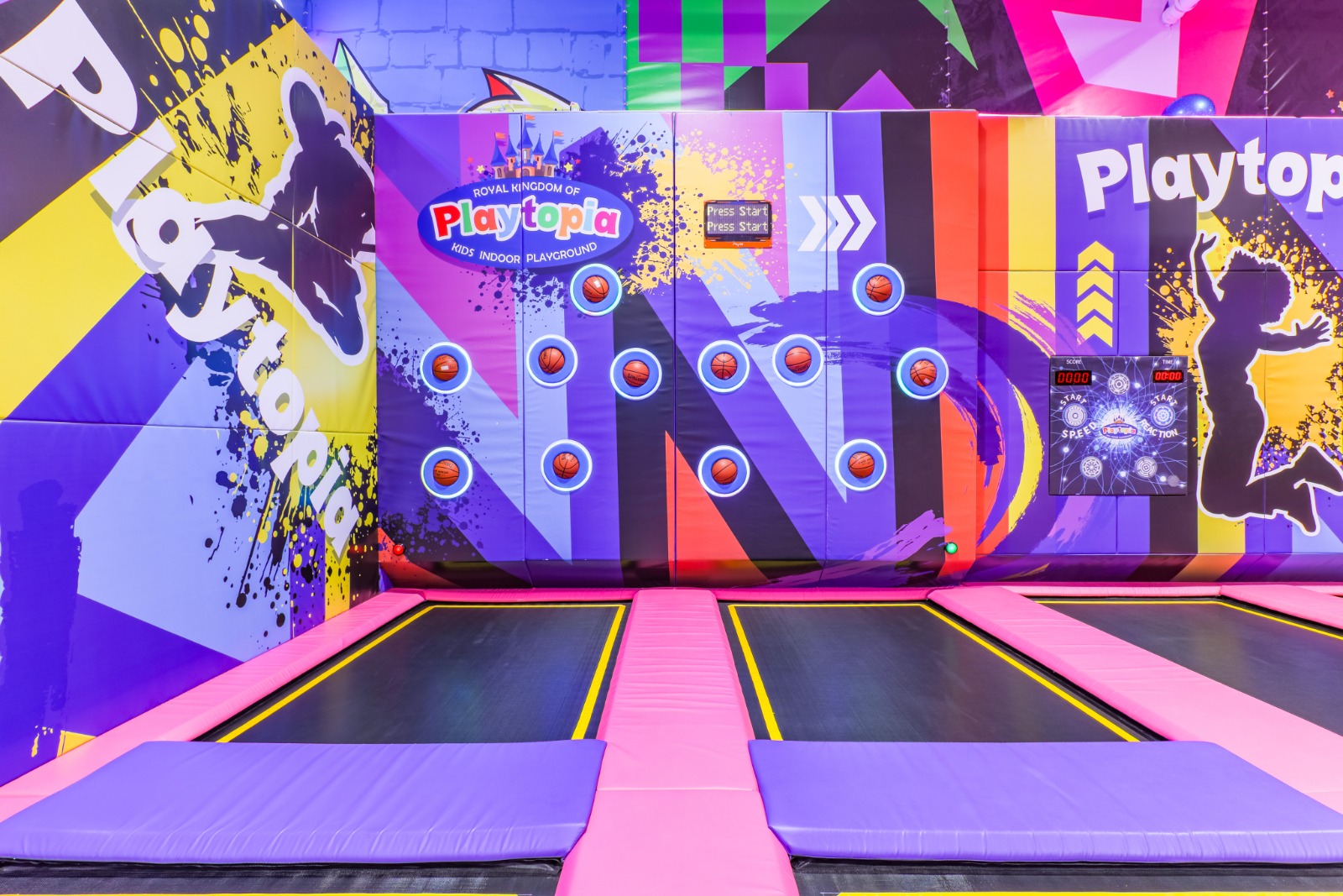 Angled wall trampolines with colorful wall graphics.