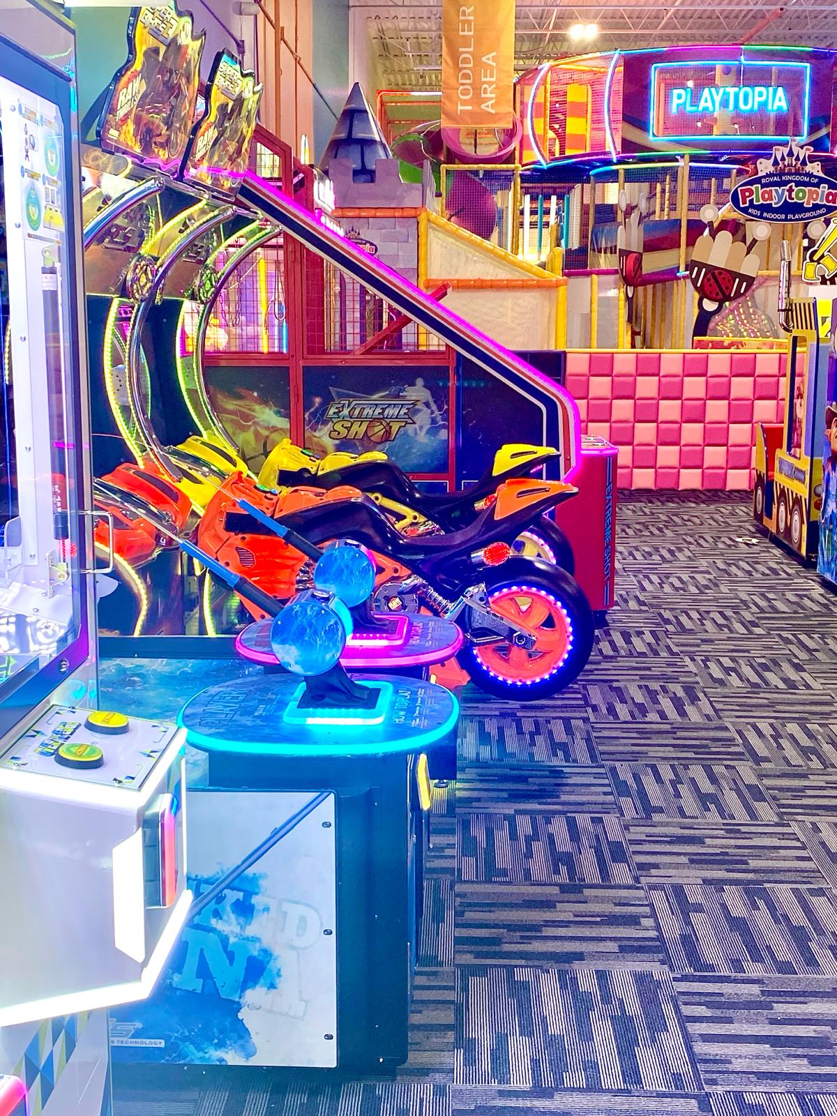 Multi-game arcade zone with colorful kiddie rides.