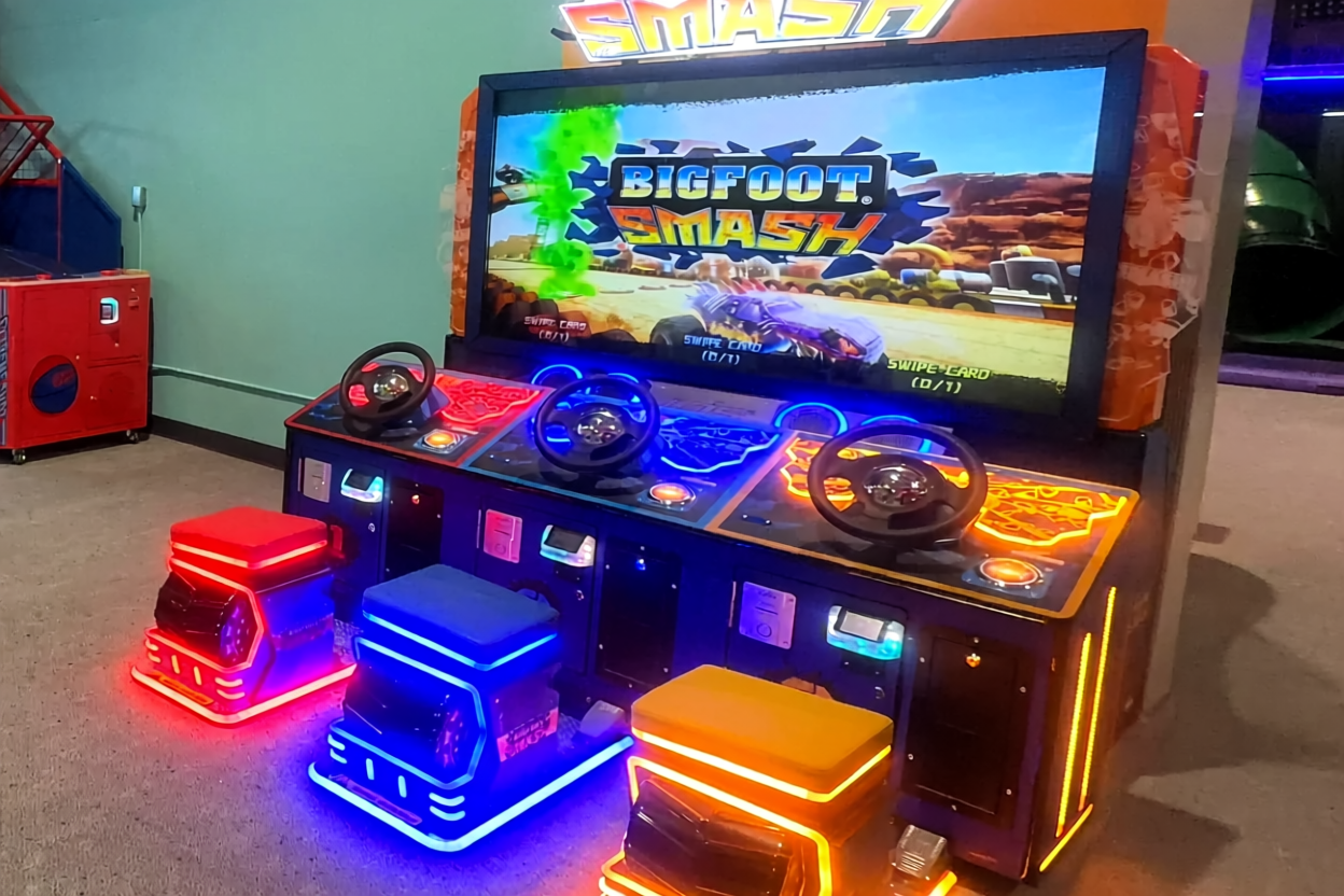 Brightly lit indoor arcade with a carousel kiddie ride.