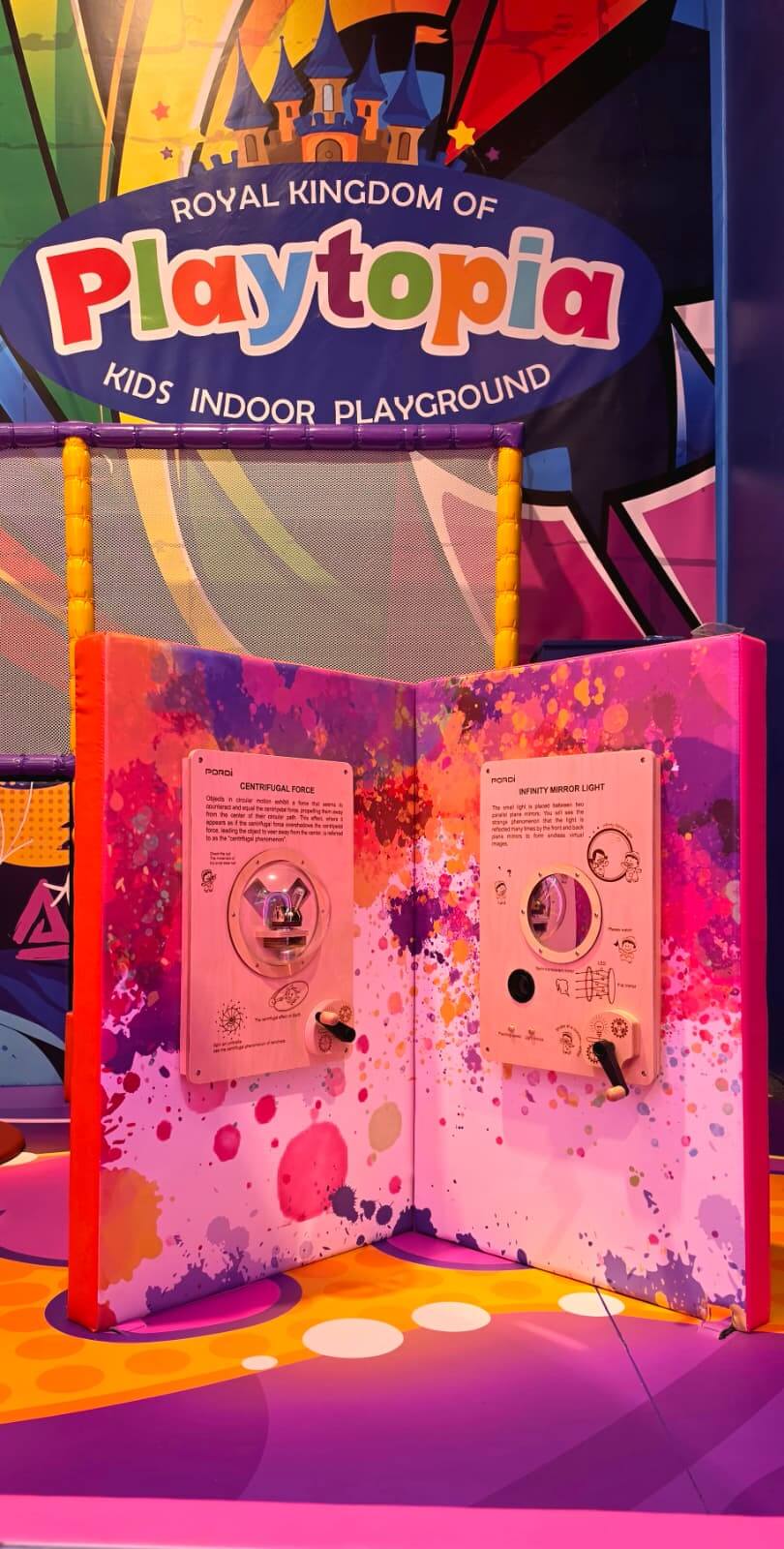 Interactive sensory wall panels with turning gears and games designed for infants and toddlers at Playtopia Burlington.