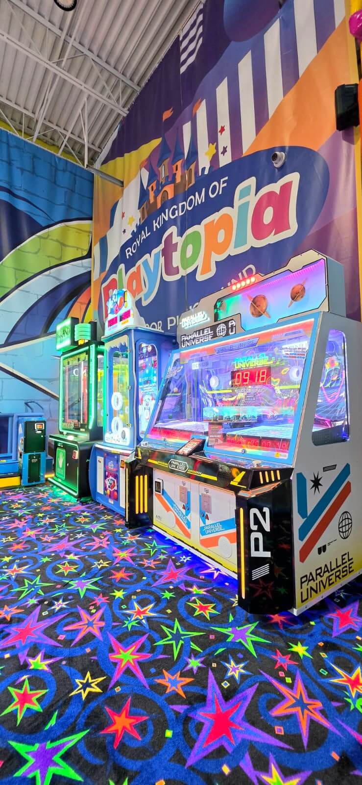 Modern redemption prize arcade cabinets featuring a digital ticket scoreboard display at Playtopia Burlington family fun center.